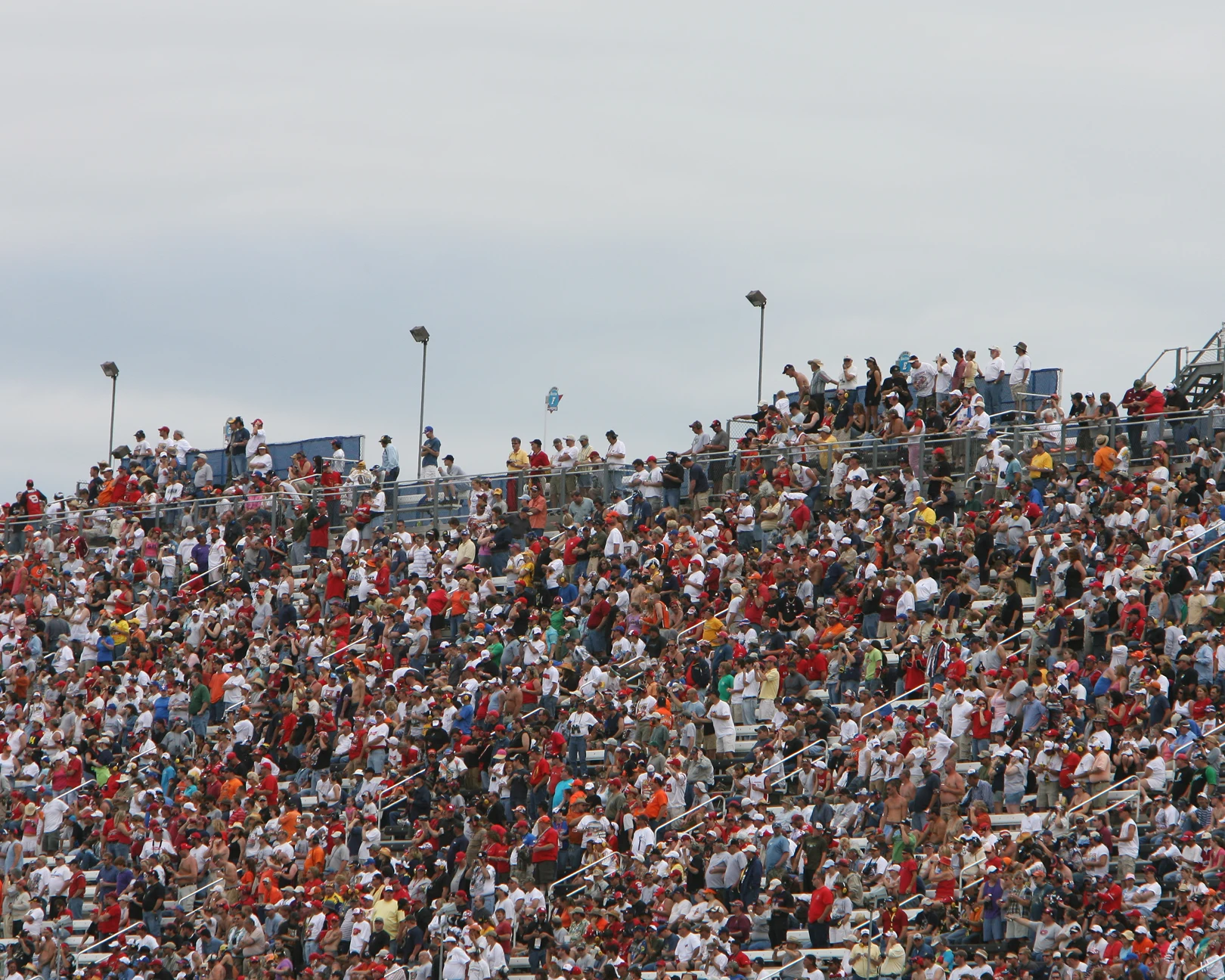 Packed bleachers under cloudy sky